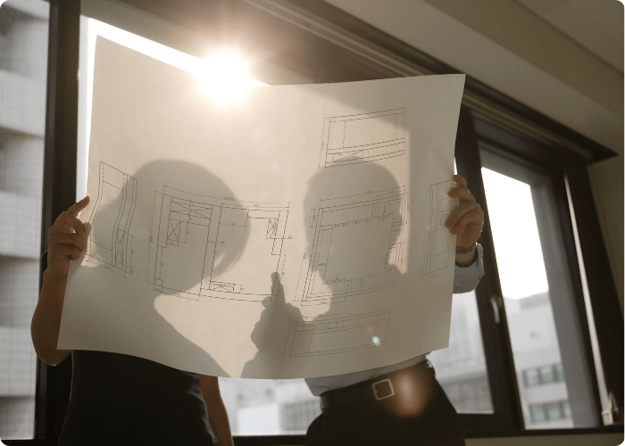 Professional safety consultant reviewing construction site blueprints and safety plans