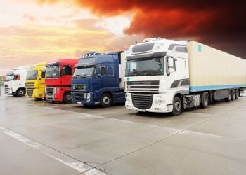 Commercial trucks and transportation fleet at logistics facility for safety management