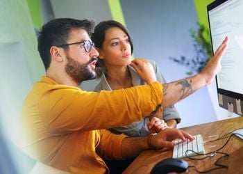 Safety professionals reviewing safety software implementation on computer