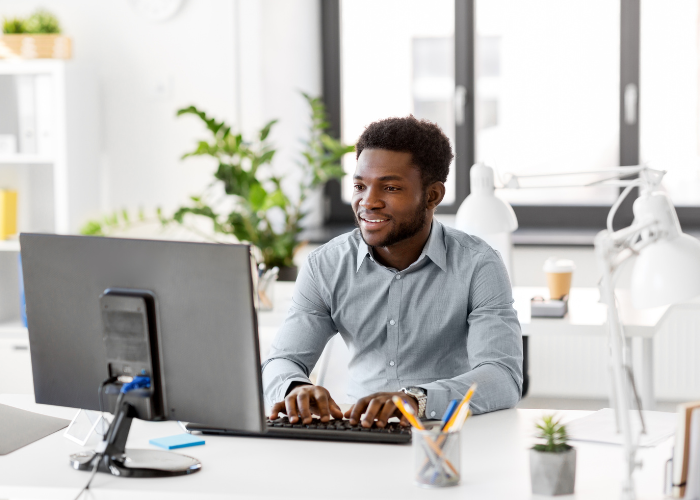 Professional using laptop for compliance portal management and safety documentation tracking