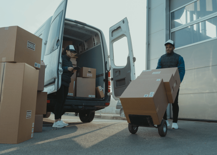 Transportation workers loading cargo into delivery truck for NSC program compliance