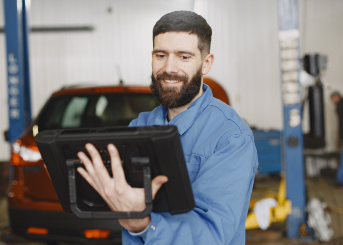 Professional safety manager using tablet device for safety software management and data tracking