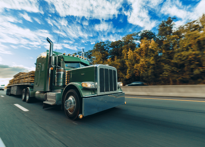 Commercial truck driving on highway demonstrating transportation safety compliance