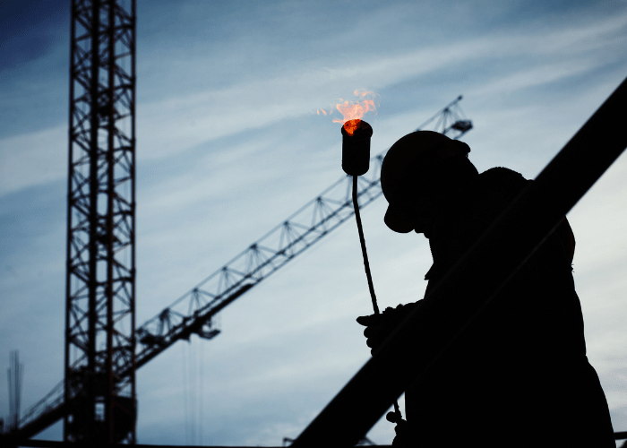 Construction crane operator working on high-rise building construction project